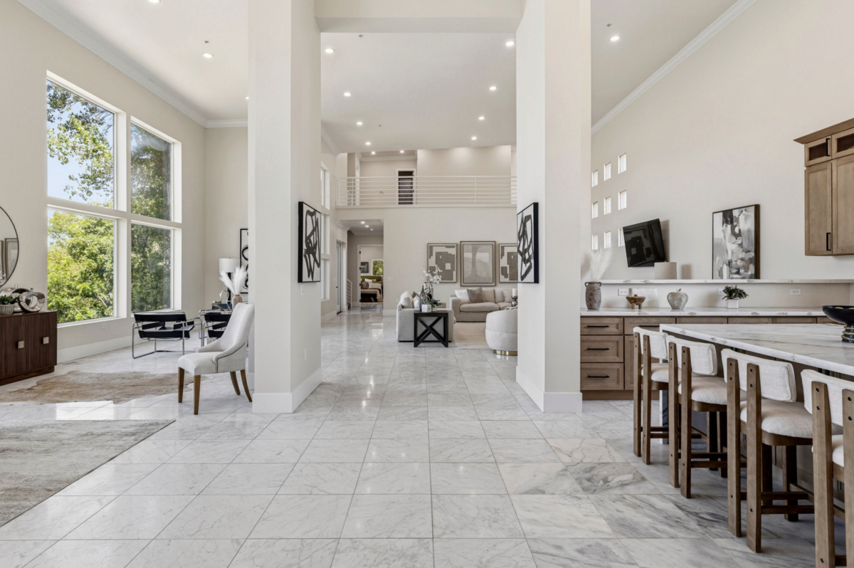 The great room inside the 7,500-square-foot home has soaring ceilings and walls of glass framing Sacramento River views.